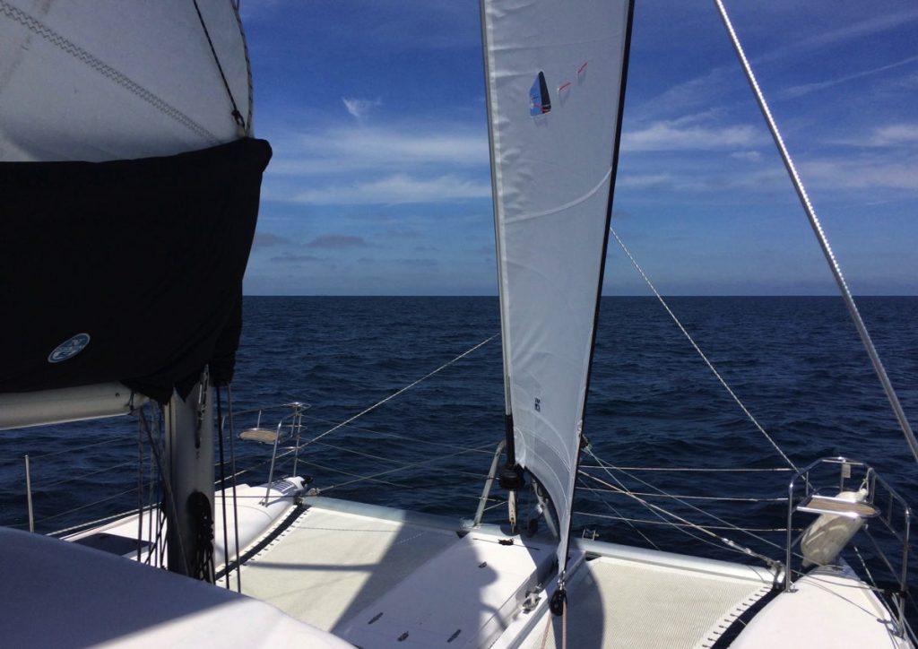 Sailing our catamaran in sunny weather to Catalina Island.